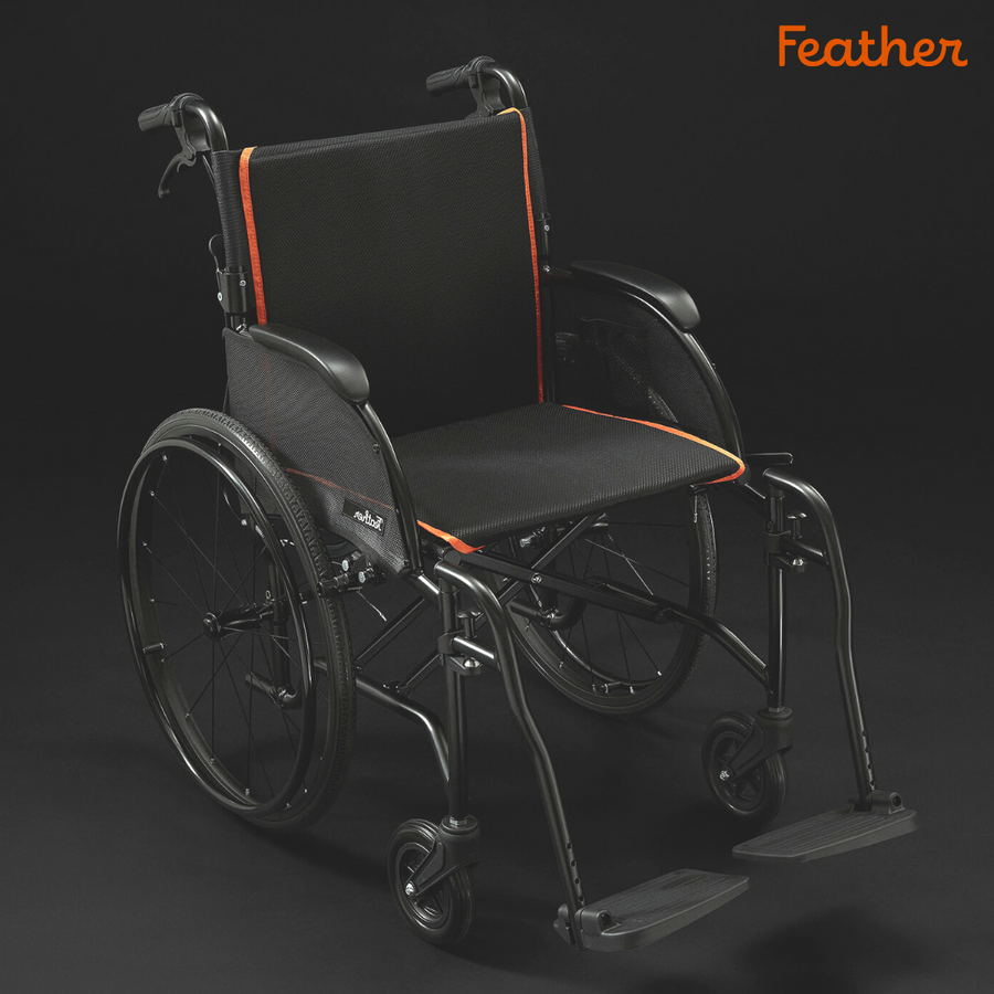 Feather Chair lightweight folding wheelchair, black with orange trim, on a dark background