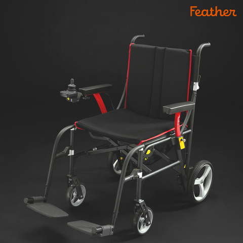 Feather power wheelchair, black with red trim, on a dark background
