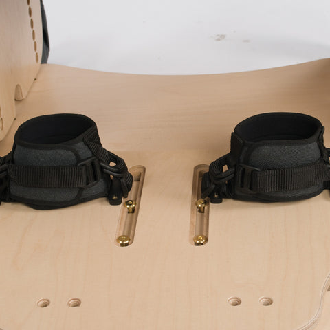 Pair of Smirthwaite heel huggies strapped to a wooden footplate