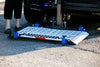Harmar AL500 (base model shown) platform lowered to the pavement behind a vehicle