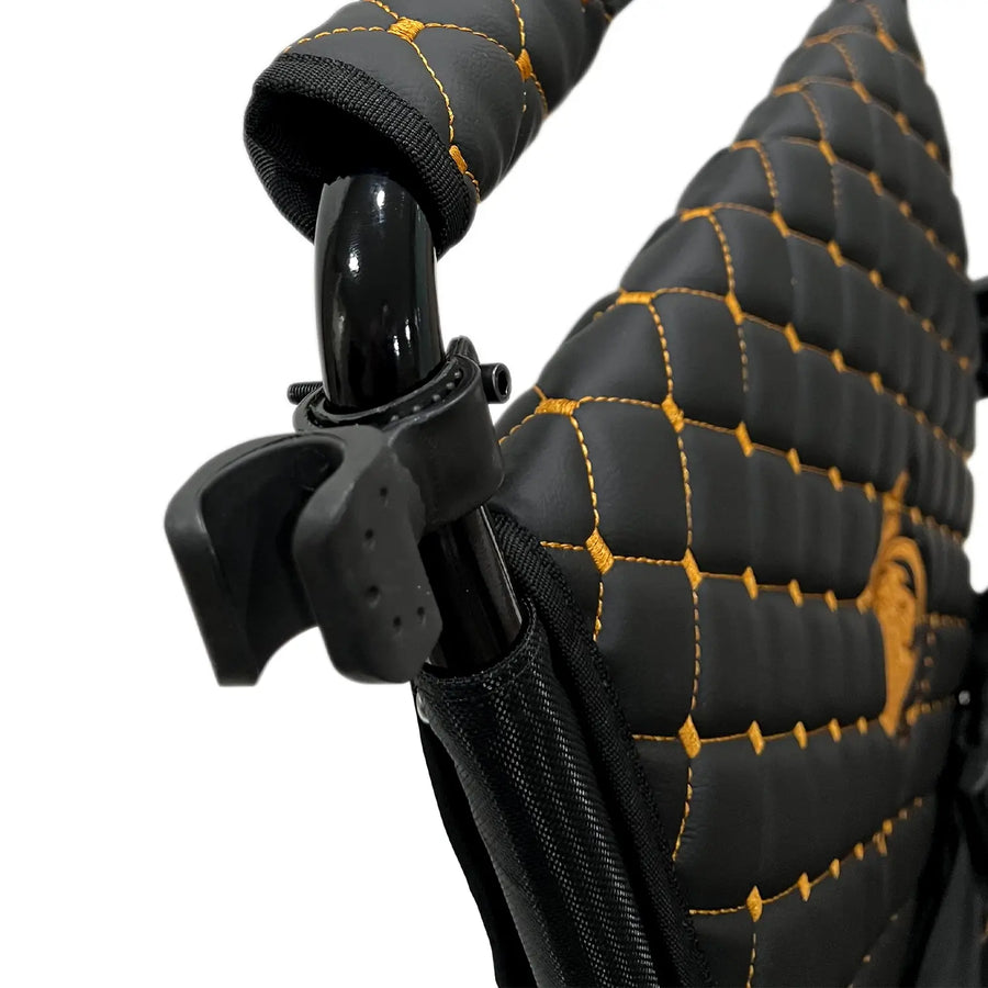 ComfyGO cane holder clamped to a wheelchair frame, holding a cane