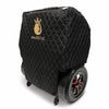 Quilted black ComfyGO travel bag covering a folded power wheelchair