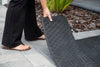 Person laying a rubber threshold ramp section