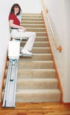 Woman riding the Harmar SL350 straight stairlift
