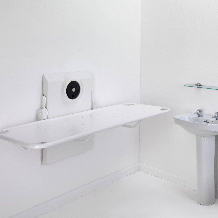 Smirthwaite wall-mounted shower stretcher, folded down in a bathroom
