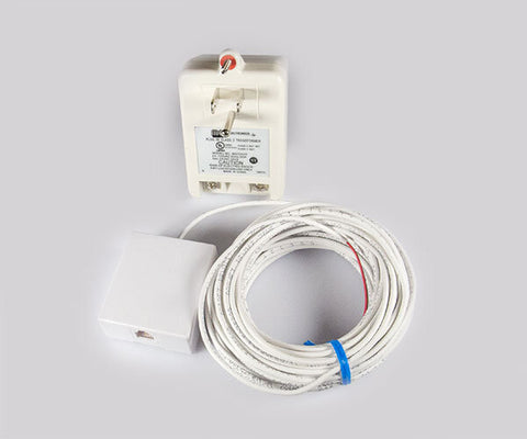 White plug-in transformer, a telephone-style wall jack and a coil of white wiring