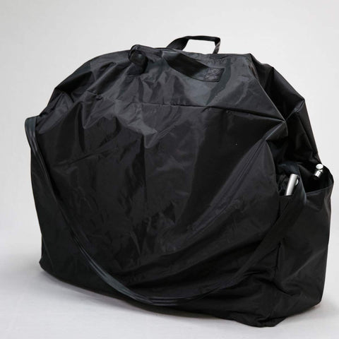 Black nylon wheelchair carry bag, zipped closed, with a top handle and a shoulder strap