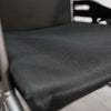 Dark grey mesh seat and back upholstery on a wheelchair, close view
