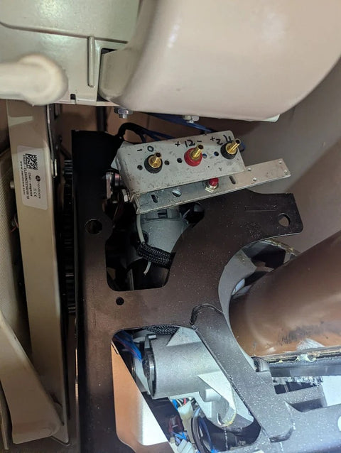 Handicare curved stairlift with its carriage cover removed, showing the drive inside
