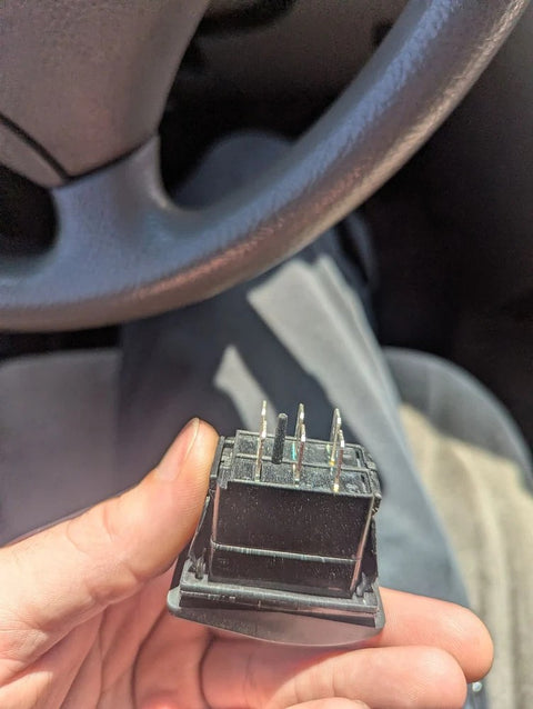 Harmar vertical platform lift switch held in a hand during a repair