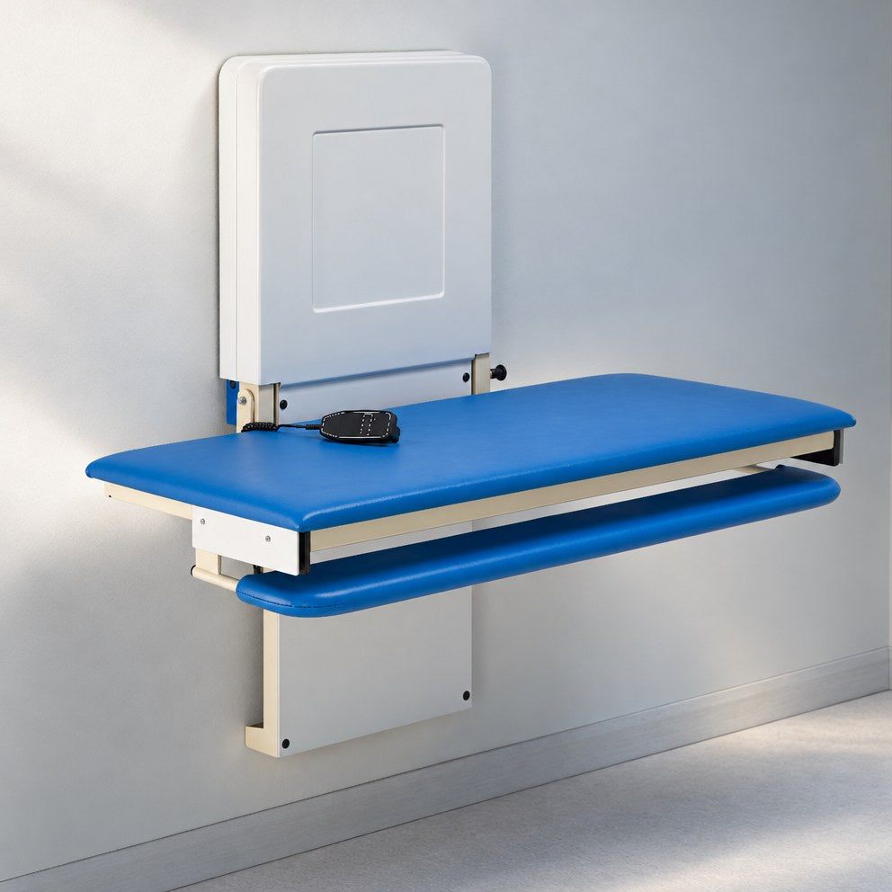 Easi-Lift changing bench mounted on a wall, with a blue padded top, padded side rail and a corded handset